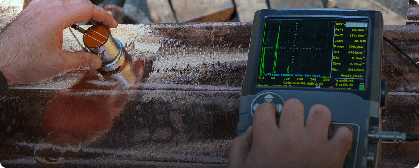 Ultrasonic testing on metal pipe with device.